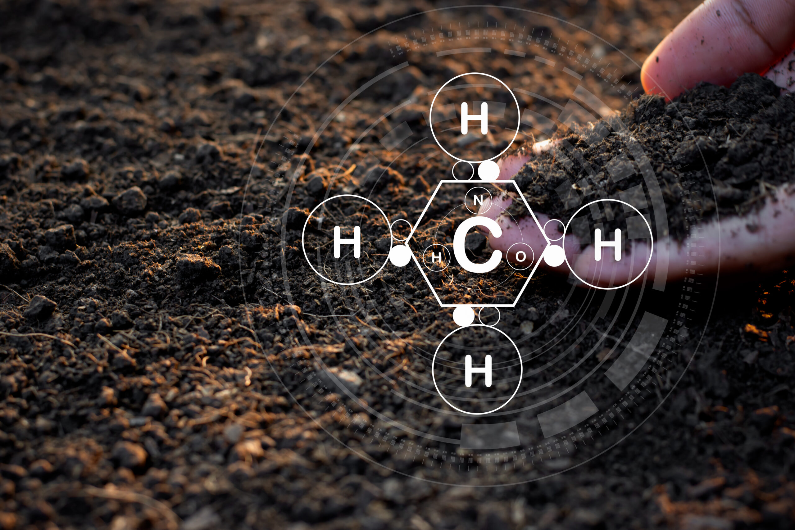 The man's hand is pouring soil with various elements for planting and there is a technology icon around organic chemistry.
